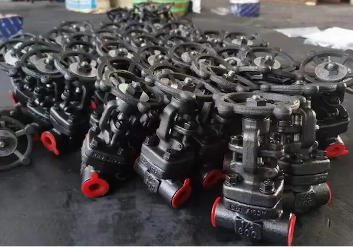 Batch of industrial forged steel valves in a factory setting Batch of industrial forged steel valves in a factory setting, showing forged valve products for high-pressure applications